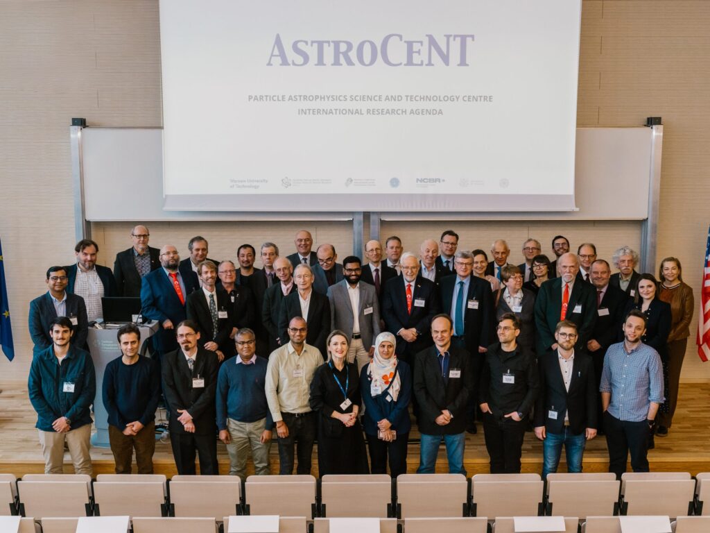 Large group posing for a group photo in a lecture hall