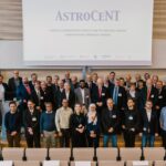 Large group posing for a group photo in a lecture hall